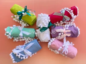 colored praying clothes white pompoms